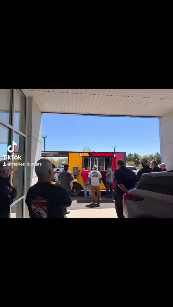Reel of Mallie's Burgers food being plated and served at an event