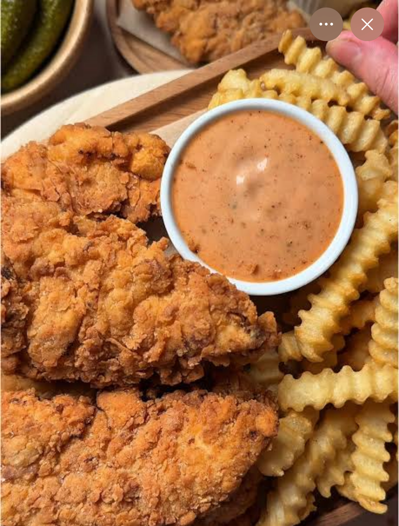 Golden hand-breaded chicken tenders served with crinkle-cut fries and dipping sauce