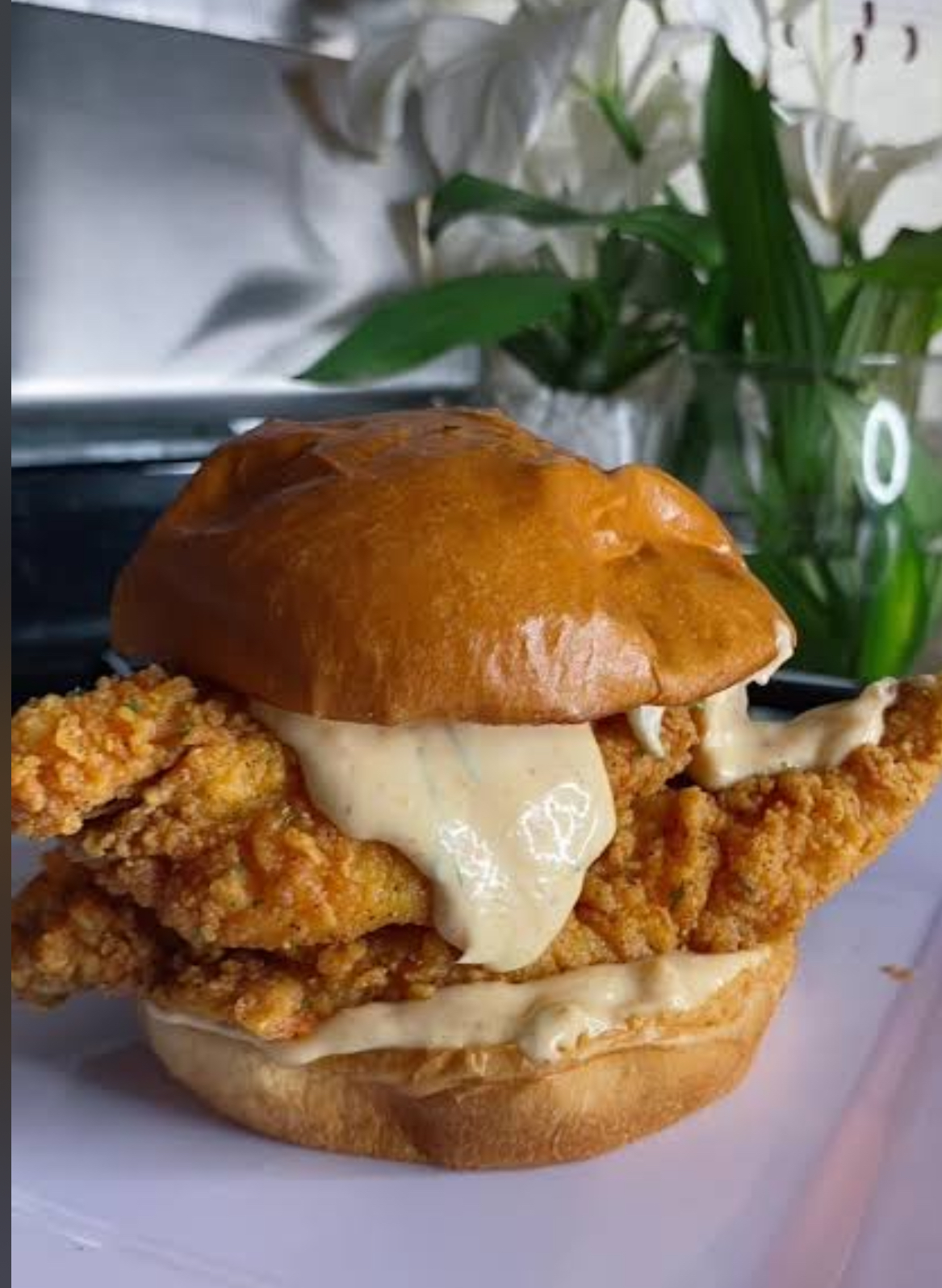Spicy chicken sandwich with crispy fried chicken and spicy mayo on a toasted brioche bun