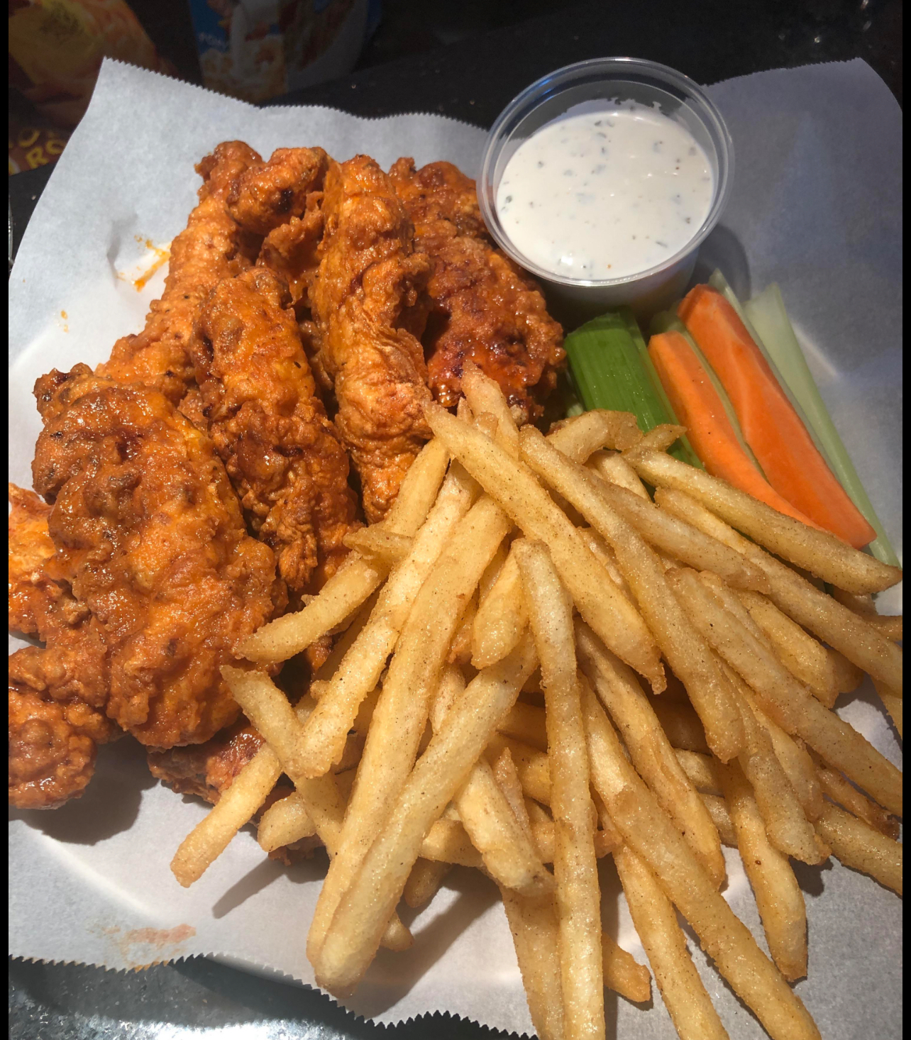 Buffalo chicken tenders with fries, celery, carrots and ranch dipping sauce