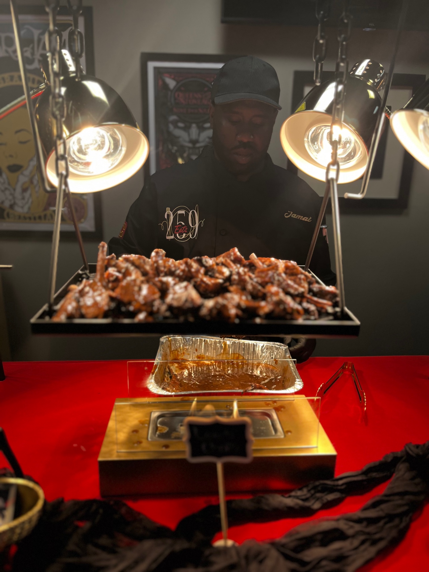 Chef Jamal serving glazed ribs from a banquet buffet line under heat lamps