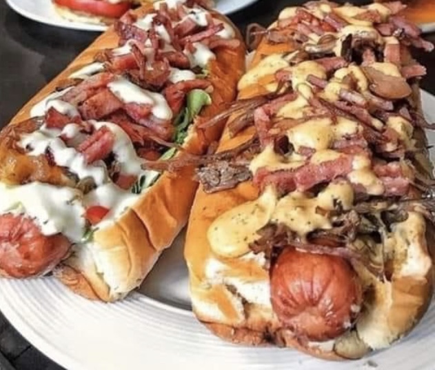 Loaded quarter-pound hot dogs piled with bacon, chili, cheese sauce, grilled onions and house sauce