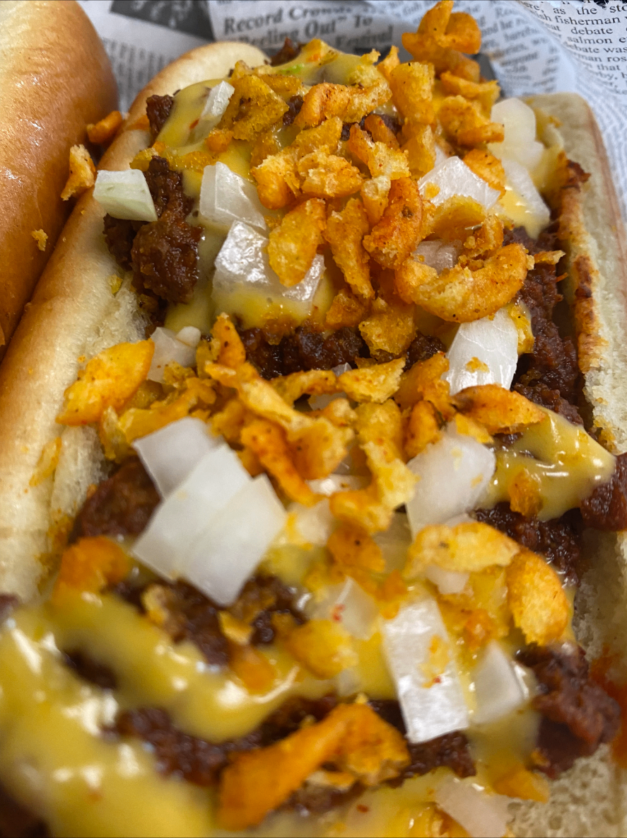 Chili cheese dog — quarter-pound beef dog smothered in house chili, cheese sauce and diced onions